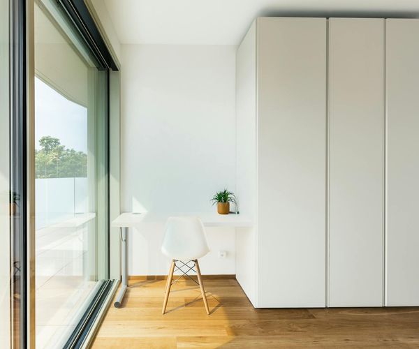 Bright and clean yoga studio with large windows and plants.